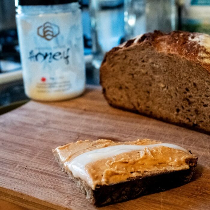 Raw honey and peanut butter on home-made multi-grain bread